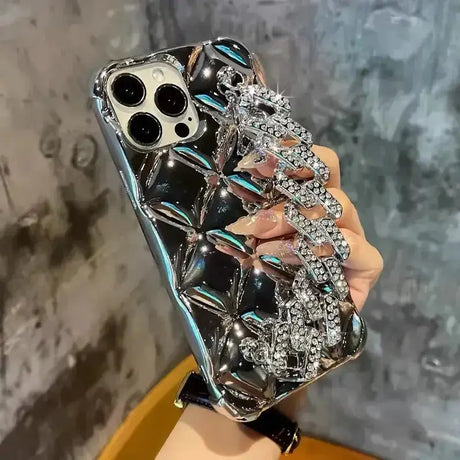 A woman holding a phone case with a diamond pattern