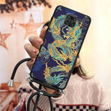 a woman holding a phone case with a dragon design