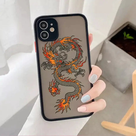 A woman holding a phone case with a dragon design