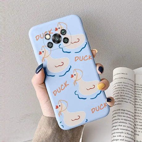 a woman holding a phone case with a duck on it