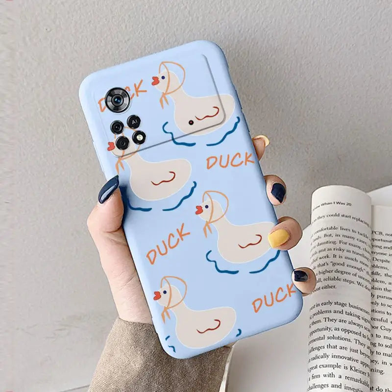 a woman holding a phone case with a duck on it