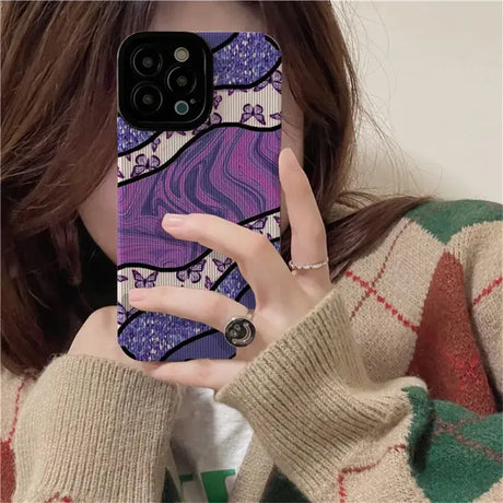 A woman holding up her phone case