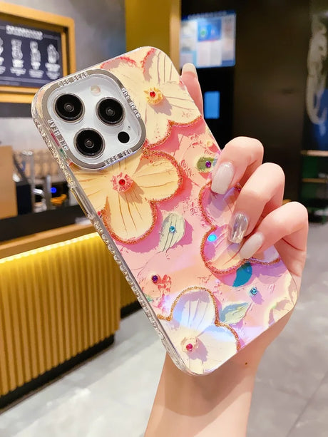 a woman holding a phone case with a floral pattern