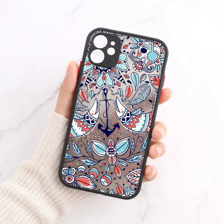 A woman holding a phone case with a floral pattern