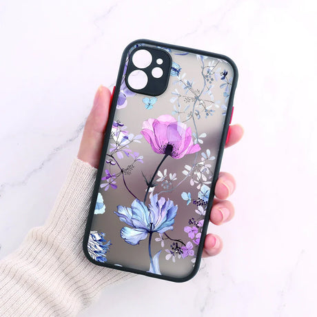 A woman holding a phone case with a floral design