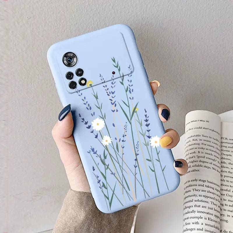 a woman holding a phone case with a flower design