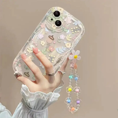 a woman holding a phone case with a flower design