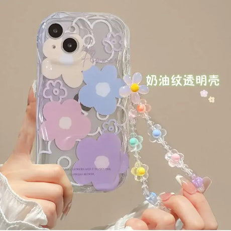 A woman holding a phone case with a flower design