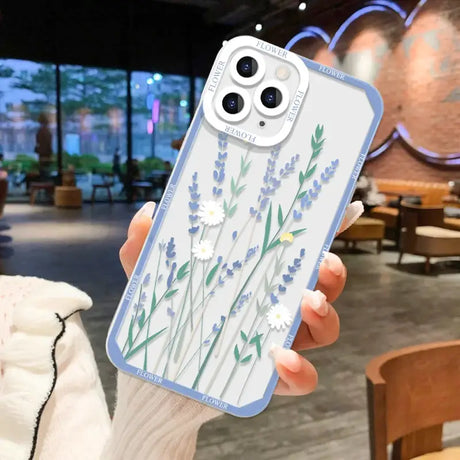 A woman holding a phone case with a flower design