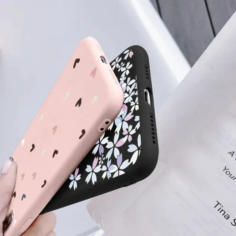 a woman holding a phone case with a flower pattern