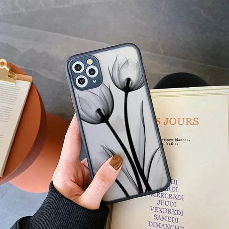 A woman holding a phone case with a flower on it