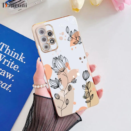 a woman holding a phone case with a flower pattern