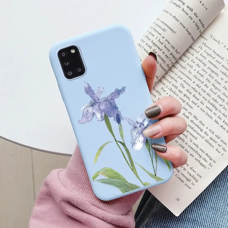 A woman holding a phone case with a flower on it