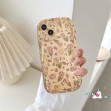 a woman holding a phone case with a flower pattern