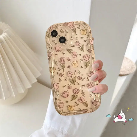 A woman holding a phone case with a flower pattern