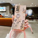 a woman holding a phone case with a flower design