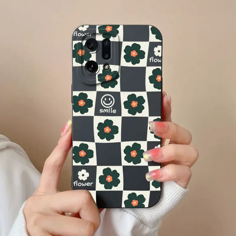 a woman holding up a phone case with a flower pattern
