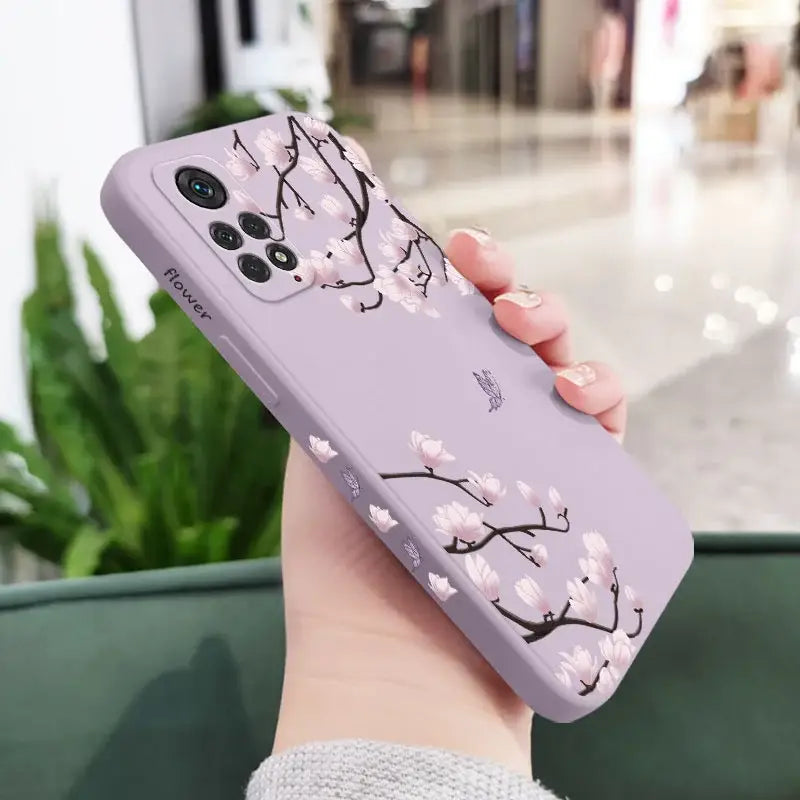 A woman holding a phone case with a flower design