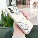 a woman holding a phone case with a flower design