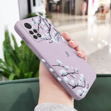 a woman holding a phone case with a flower pattern