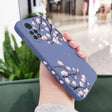 A woman holding a phone case with a flower design