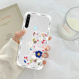 a woman holding a phone case with flowers on it