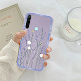 a woman holding a phone case with flowers on it