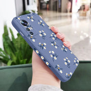 a woman holding a phone case with flowers on it