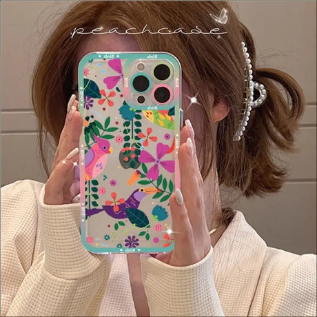 A woman holding up her phone case