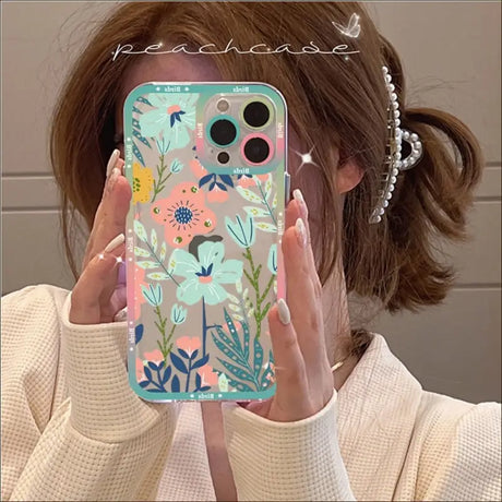 A woman holding up her phone case