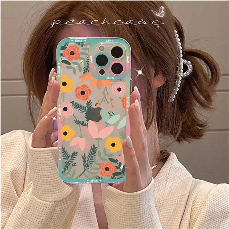 a woman holding up her phone case