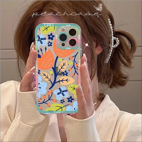 A woman holding up her phone case