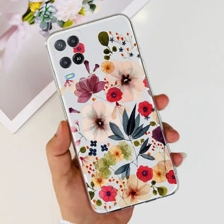 a woman holding a phone case with flowers on it
