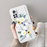 A woman holding a phone case with flowers on it