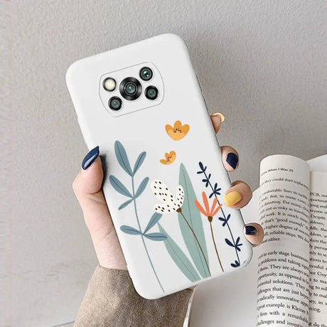 a woman holding a phone case with flowers on it