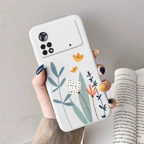 A woman holding a phone case with flowers on it