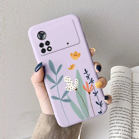 A woman holding a phone case with flowers on it