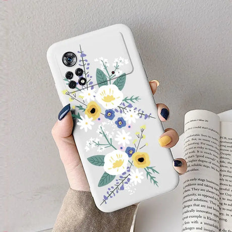 A woman holding a phone case with flowers on it