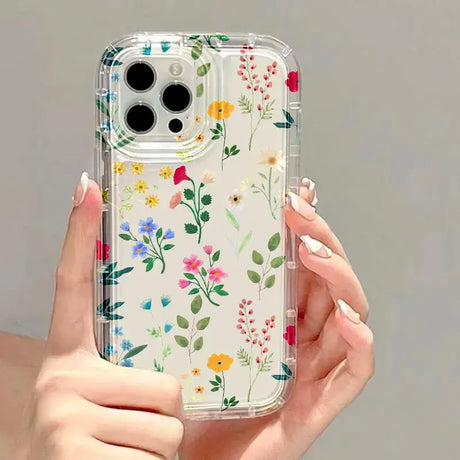 A woman holding a phone case with flowers on it