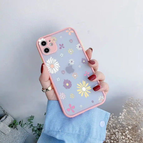 A woman holding a phone case with flowers on it