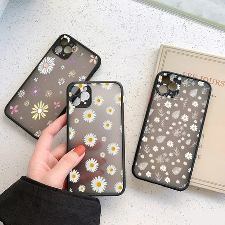 A woman holding a phone case with flowers on it