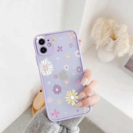 A woman holding a phone case with flowers on it