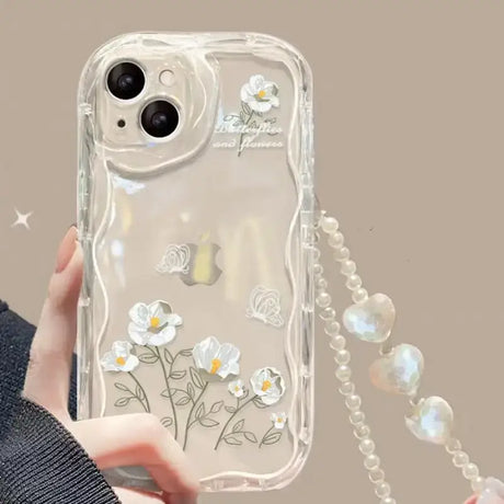 a woman holding a phone case with flowers on it