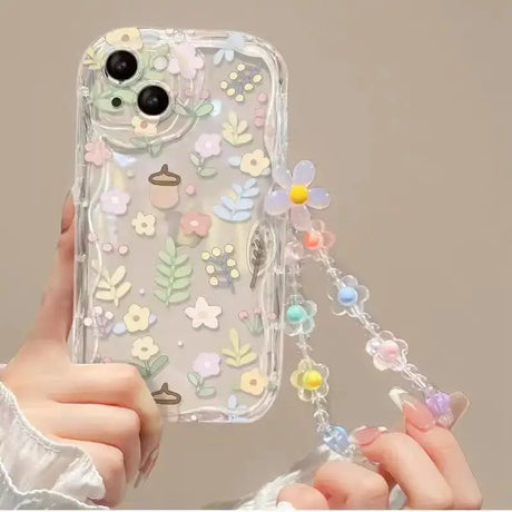 a woman holding a phone case with flowers on it