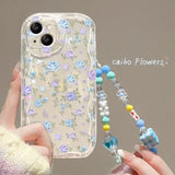 a woman holding a phone case with flowers and beads