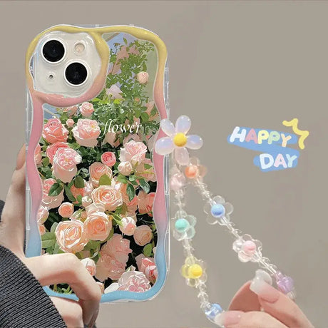 A woman holding a phone case with flowers