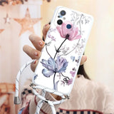 a woman holding a phone case with flowers on it