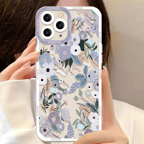 A woman holding a phone case with flowers on it