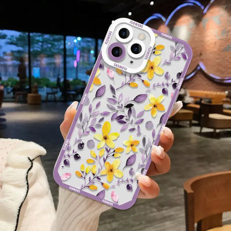 A woman holding a phone case with flowers on it