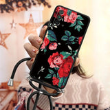 a woman holding a phone case with flowers on it